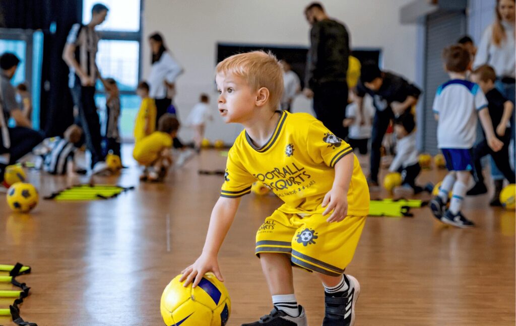 Kid playing at football class