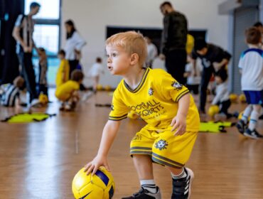 Kid playing at football class