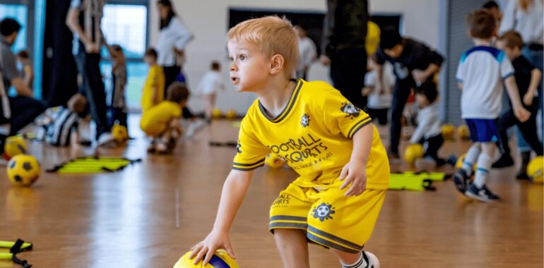 Kid playing at football class